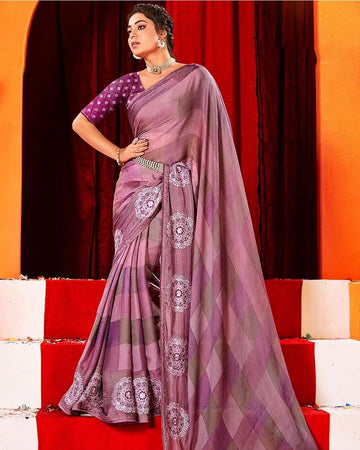Woman in a purple saree with white patterns on a red and orange background